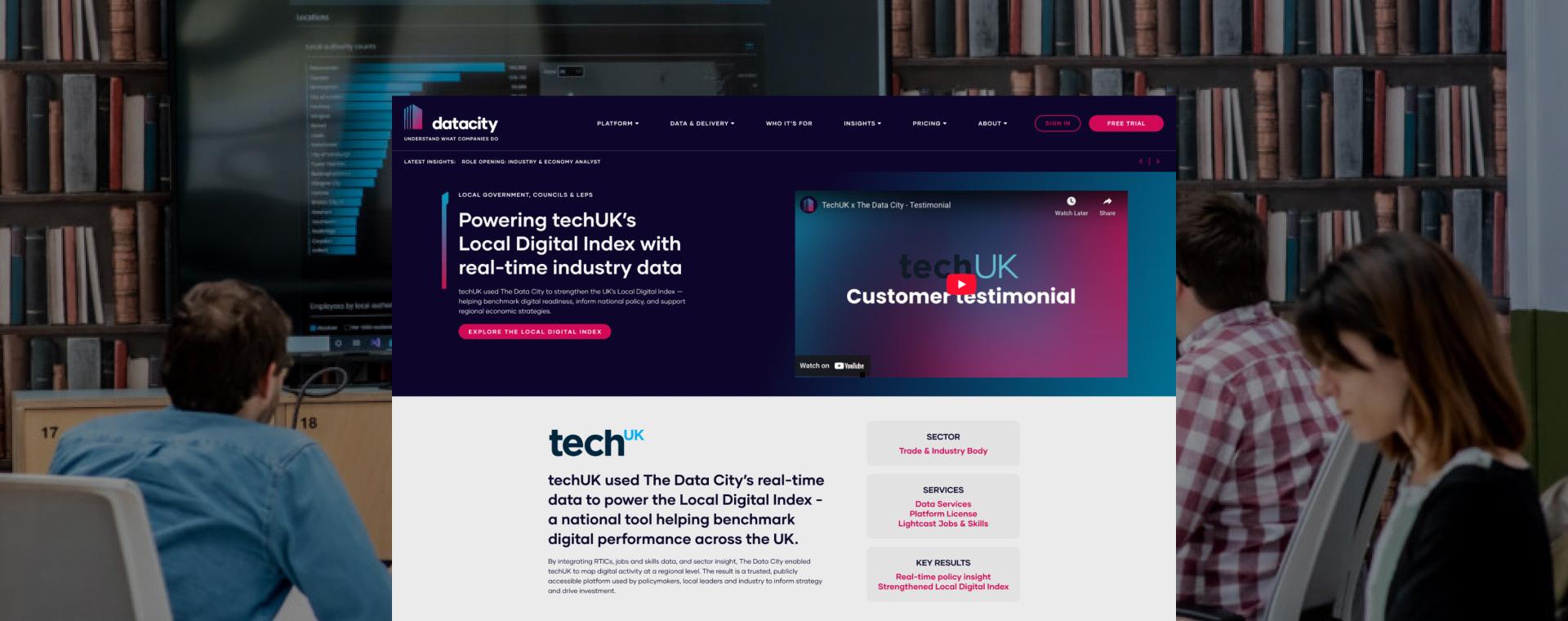 Website homepage overlayed on a library scene with people studying.