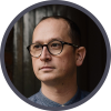 Dan Harper, A person wearing glasses, looking thoughtful.